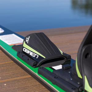 Close-up of a green and black water ski  on a wooden dock.