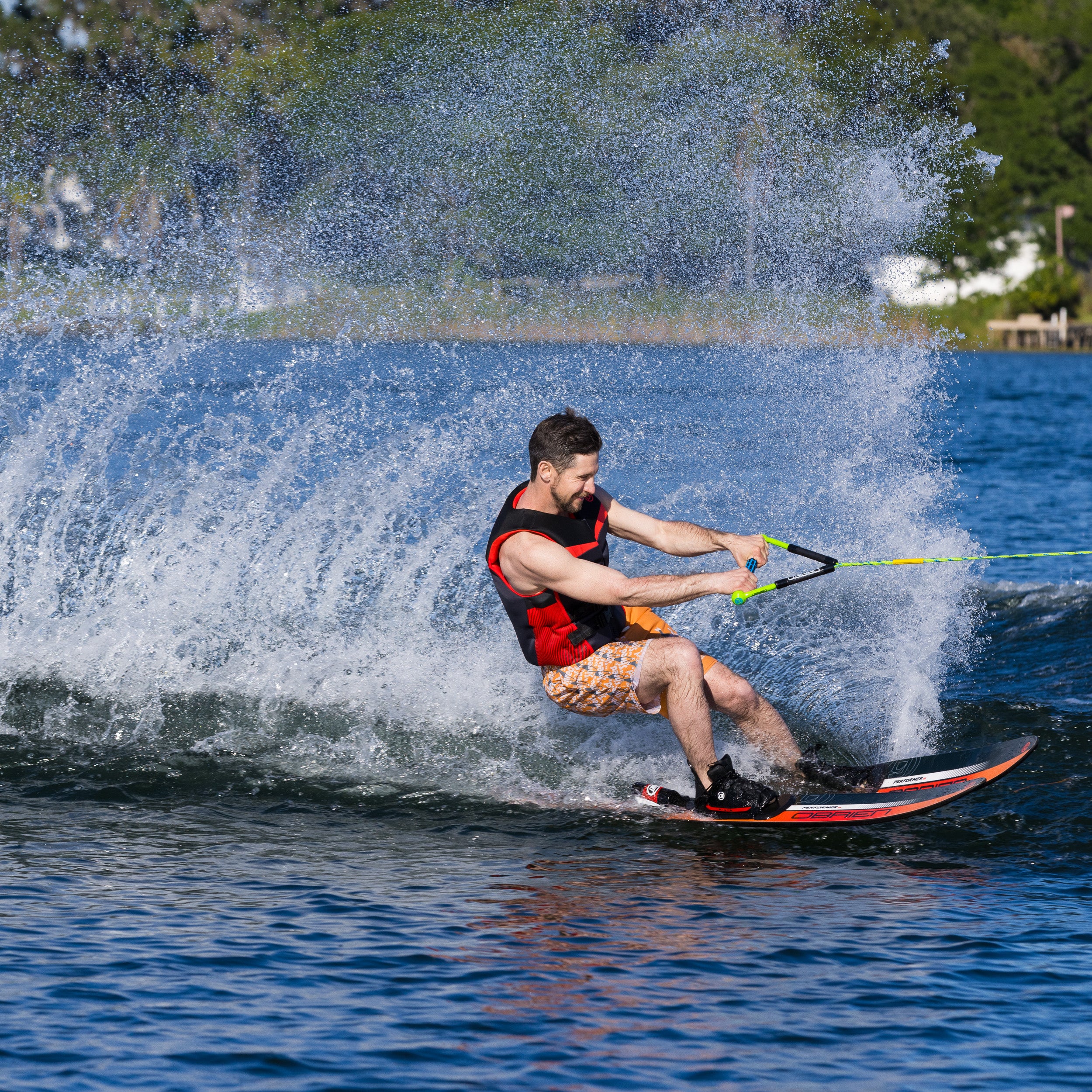Person water skiing on a lake with a splash of water